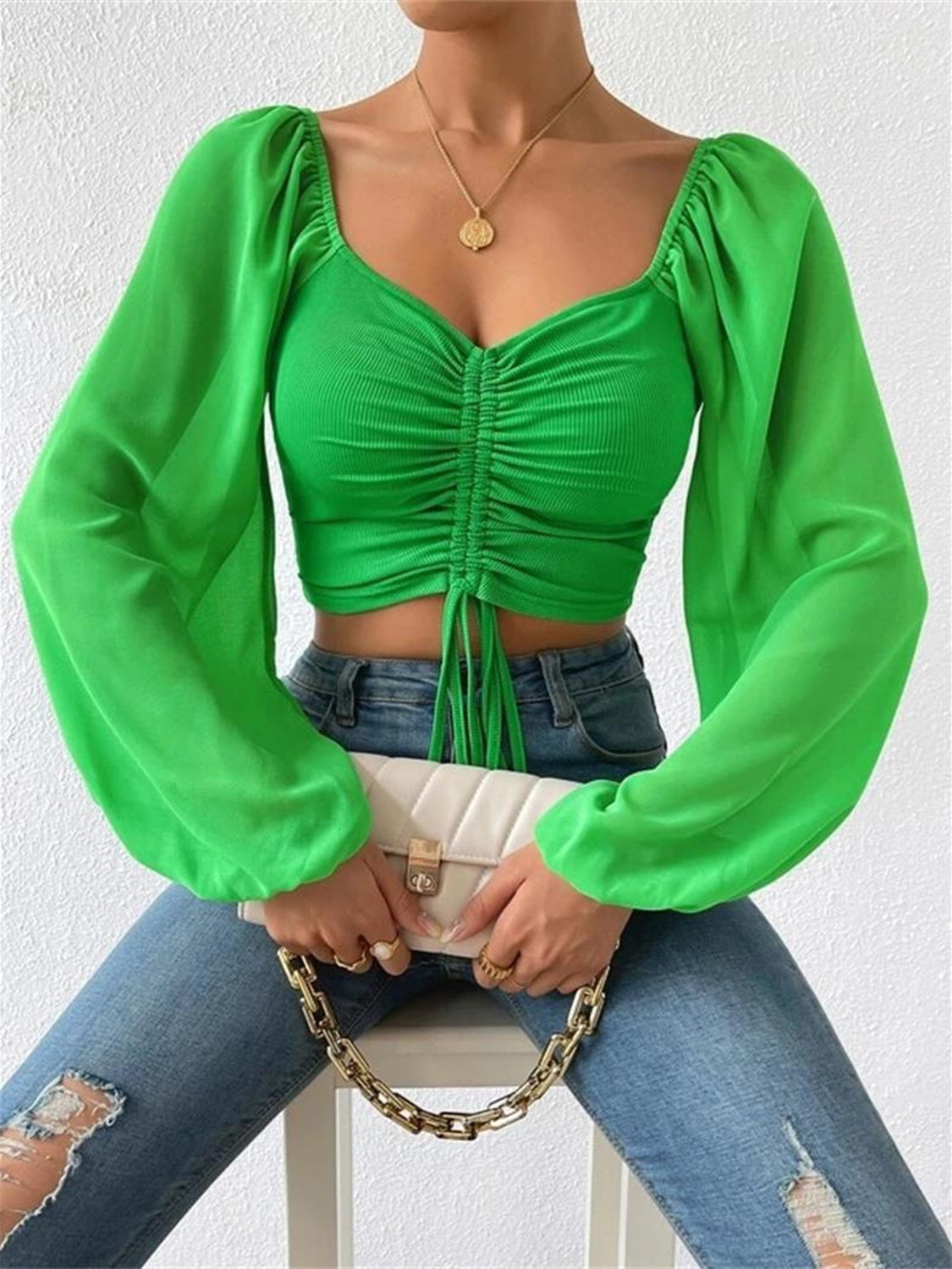 Lime green ruched bodice puff sleeve crop top with drawstring detail and square neckline.