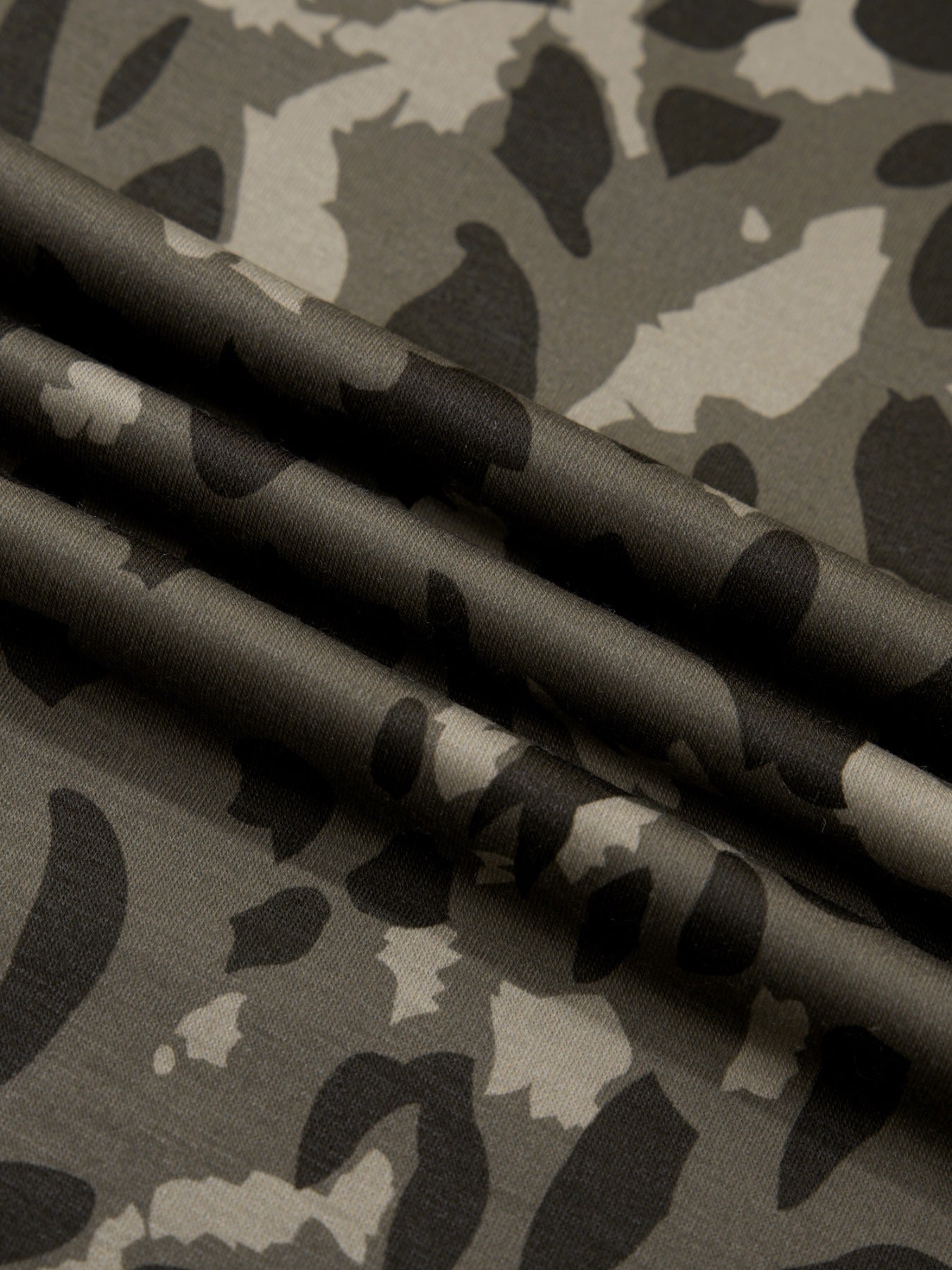 Sleek mock neck tee in a grey camouflage print fabric.