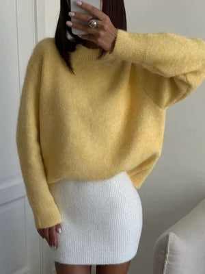 Pastel yellow cozy knit sweater with relaxed fit and crew neck.