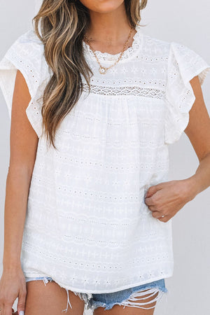 White eyelet blouse with ruffle sleeves and lace yoke detail.