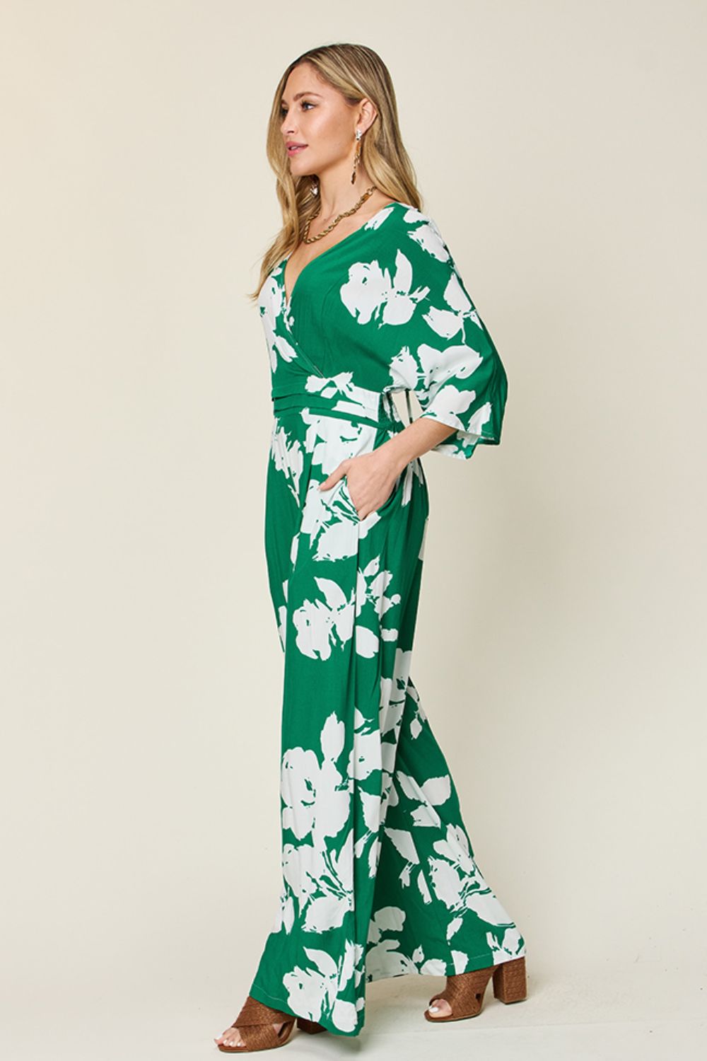Green floral kimono jumpsuit with wide legs and a V-neck.