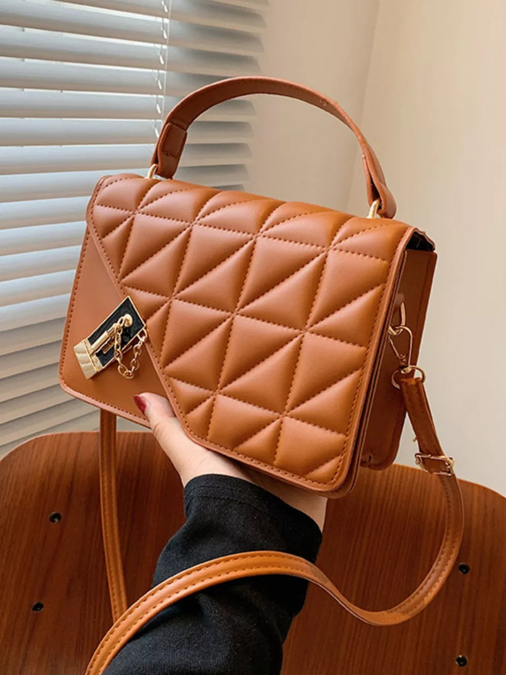 Diamond quilted PU leather crossbody bag in caramel with gold hardware and chain detail.