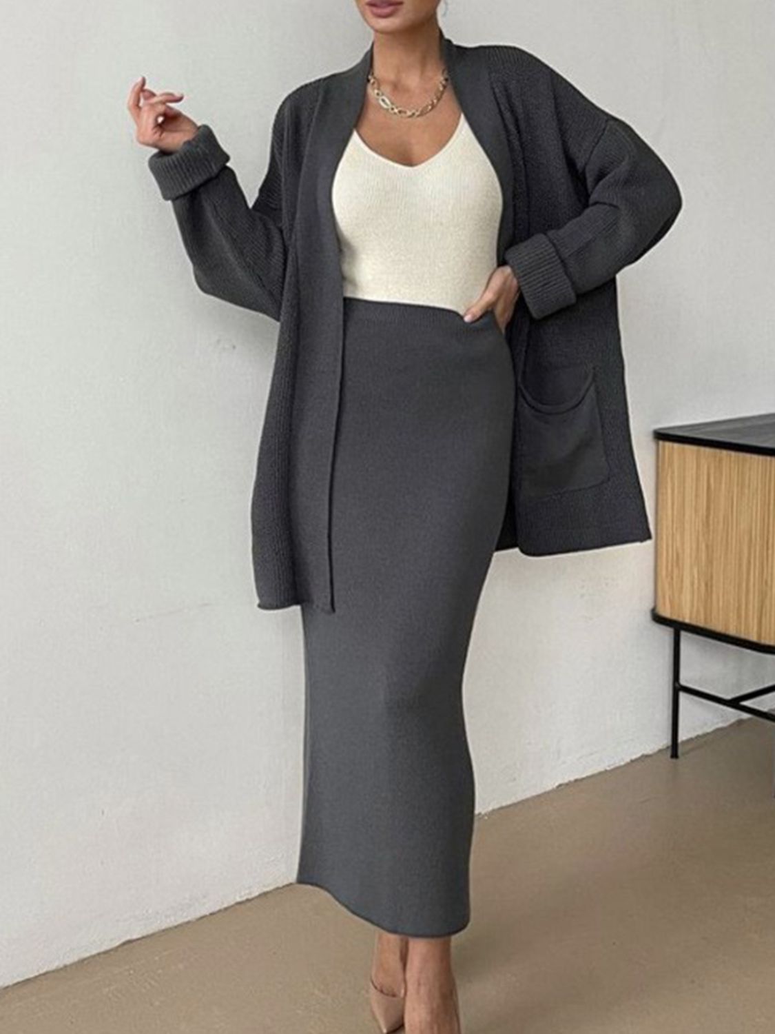 Dark gray ribbed knit co-ord set with open cardigan and pencil skirt, acrylic material.