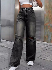 Distressed wash wide leg jeans in dark gray with ripped knees.