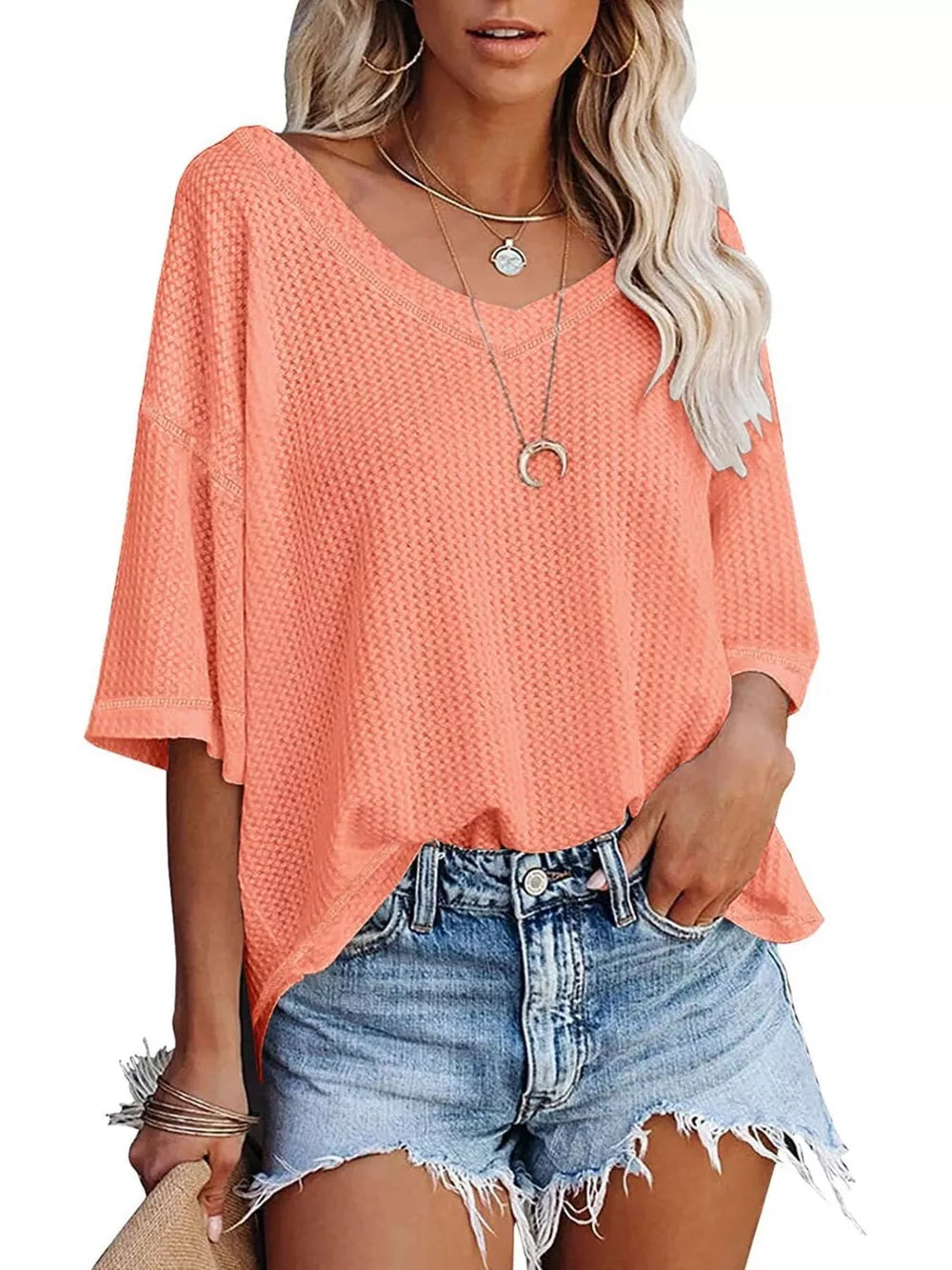 Coral pink waffle knit relaxed V-neck t-shirt with short sleeves.