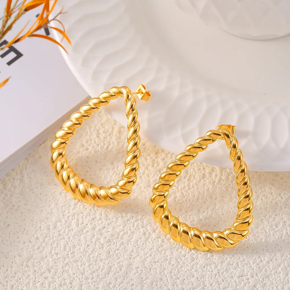 Gold teardrop hoop earrings with rope texture detail