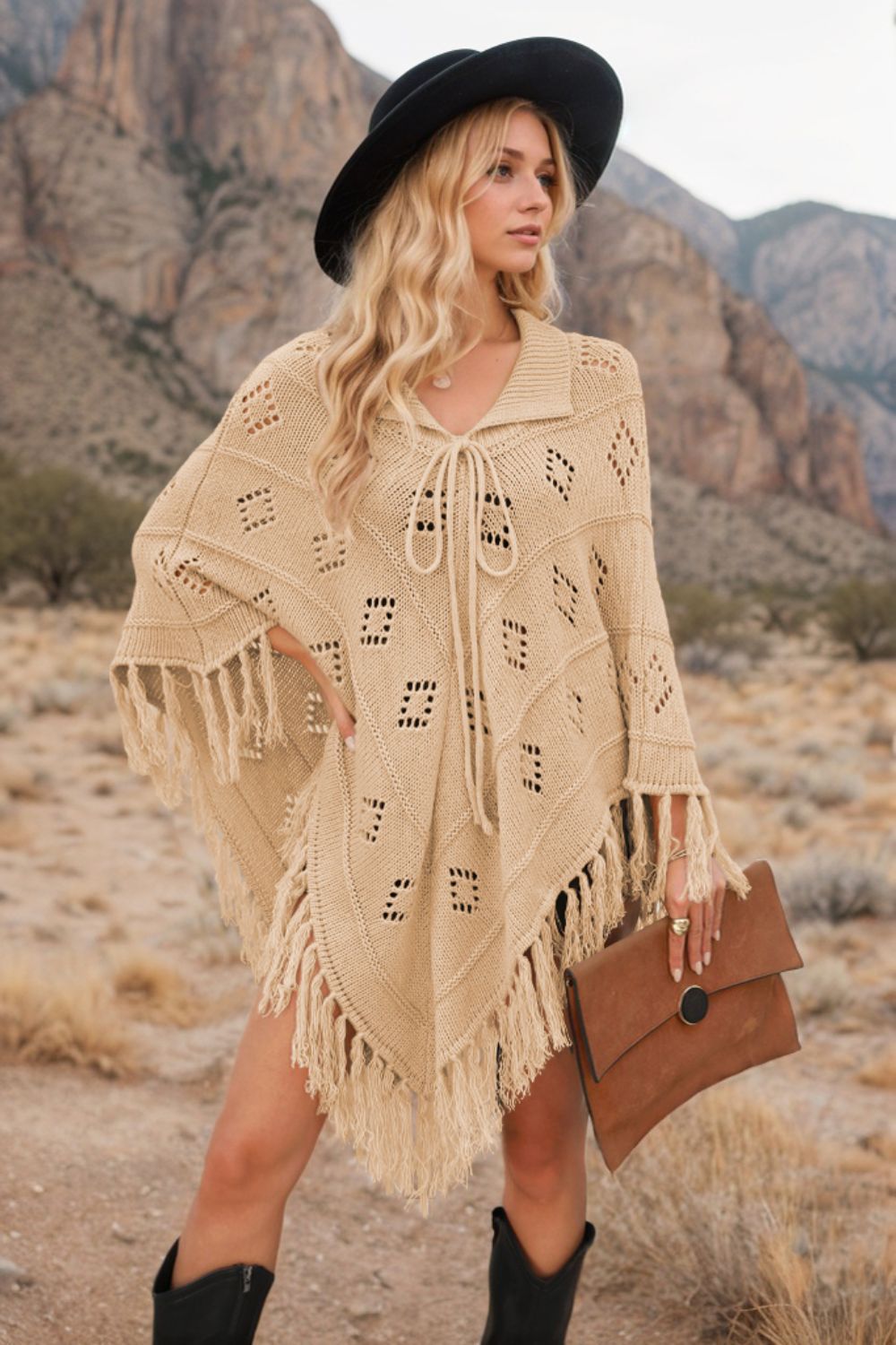 Tan geometric knit poncho with fringe and tie neck, acrylic material.