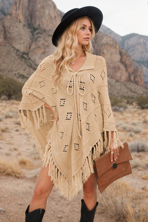 Tan geometric knit poncho with fringe and tie neck, acrylic material.