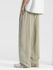 Men's relaxed fit beige sweatpants with drawstring waist and pockets.