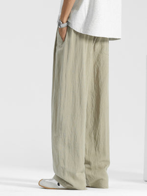 Men's relaxed fit beige sweatpants with drawstring waist and pockets.