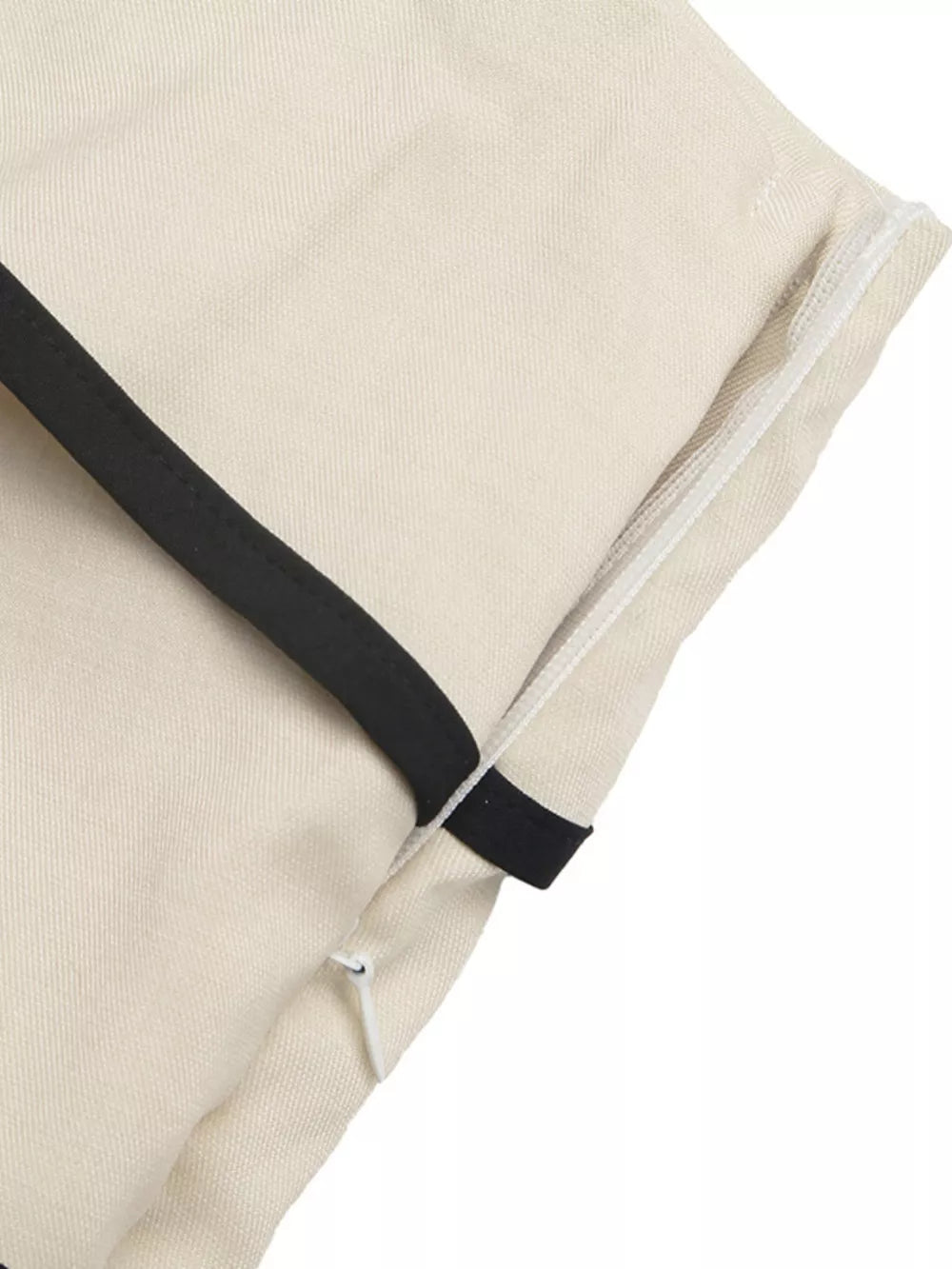 Cream maternity romper with black trim and side zipper detail