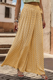 Yellow geometric print wide-leg palazzo trousers with a tie waist detail.