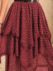 Burgundy tiered midi skirt with white polka dots and lace trim detail.
