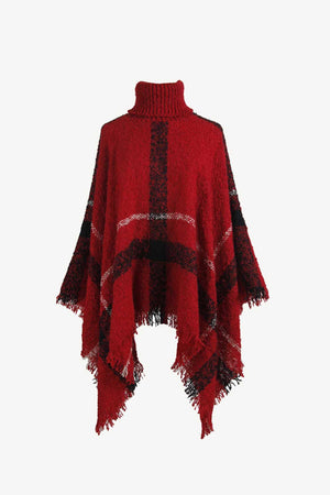 Deep red plaid turtleneck cape with fringe detail and acrylic texture.