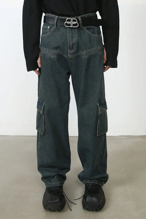 Panelled dark wash denim cargo pants with multiple pockets and a relaxed fit.