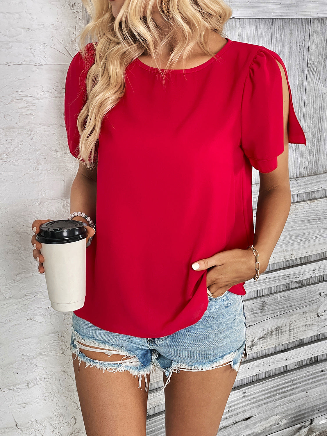 Red slit sleeve blouse with crew neck and casual styling.