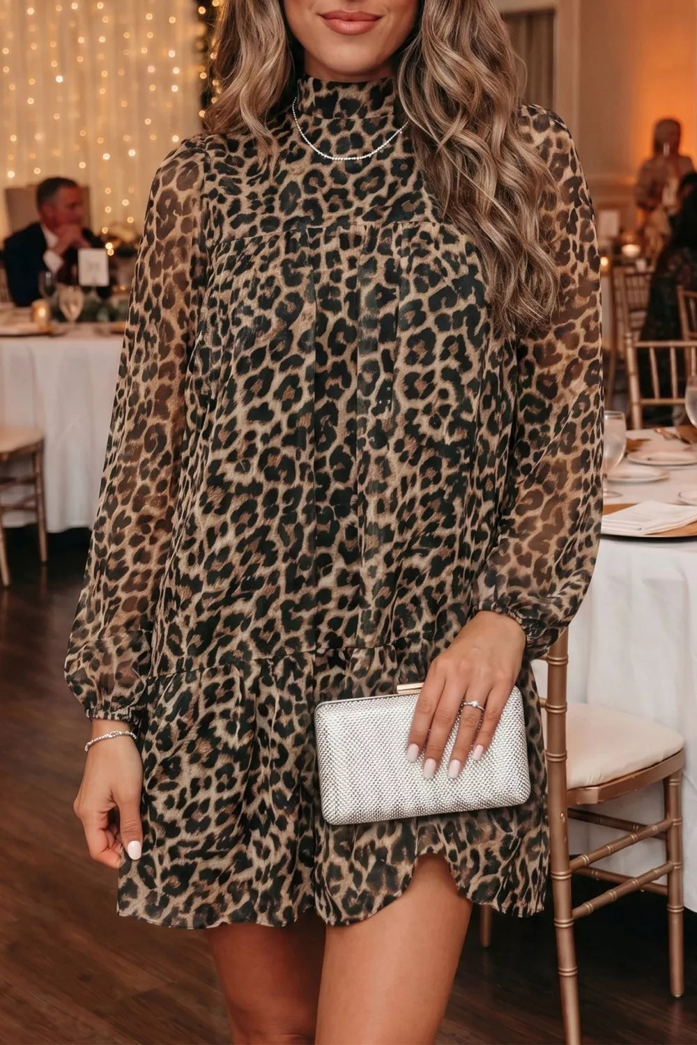 Chic leopard print tiered shift dress with long sleeves and mock neck.