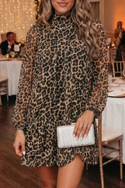 Chic leopard print tiered shift dress with long sleeves and mock neck.
