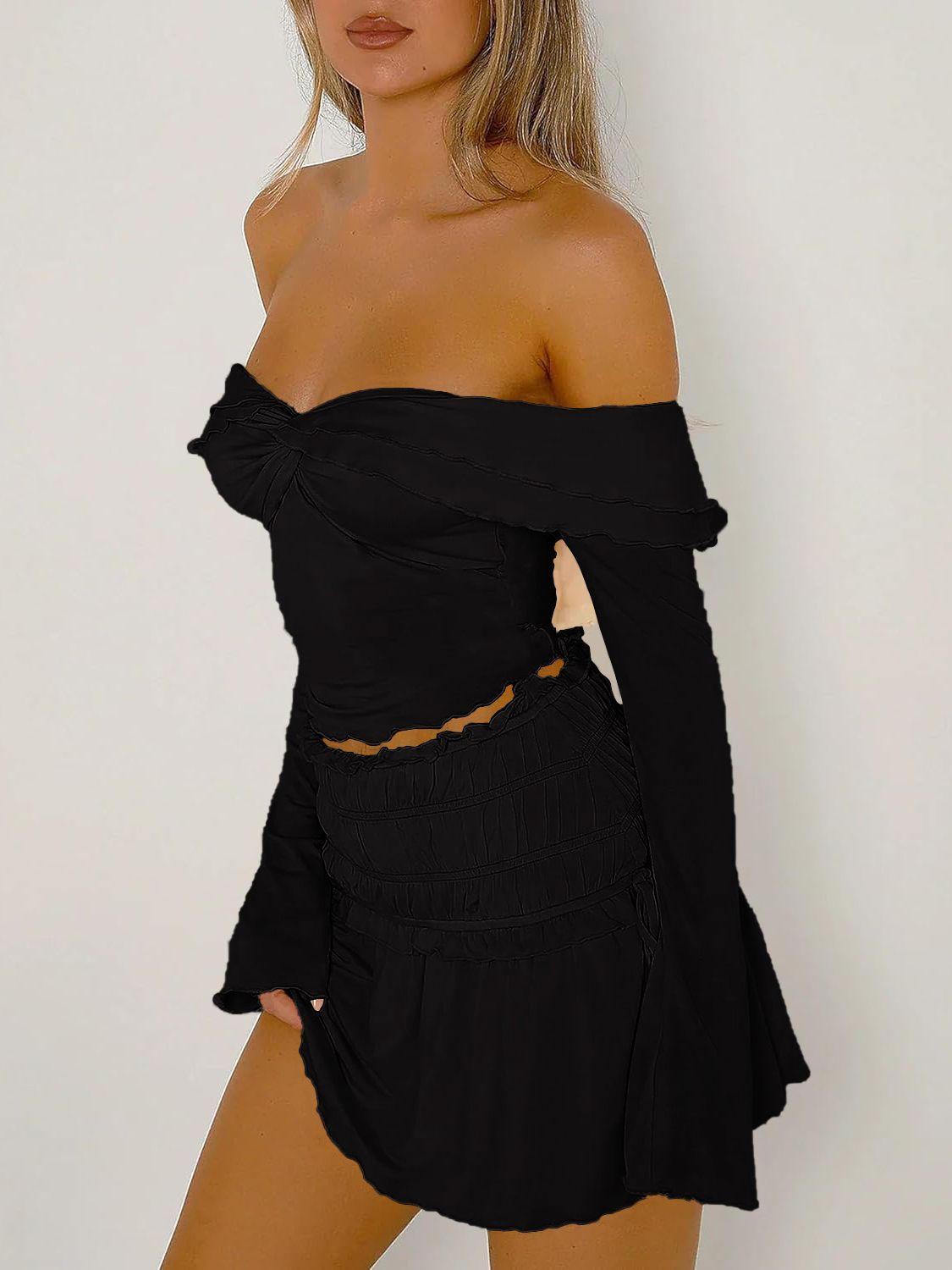 Black ruched bodice off-shoulder top with long sleeves and a sweetheart neckline.