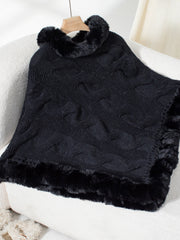 Black cable knit poncho with faux fur trim and collar detail.