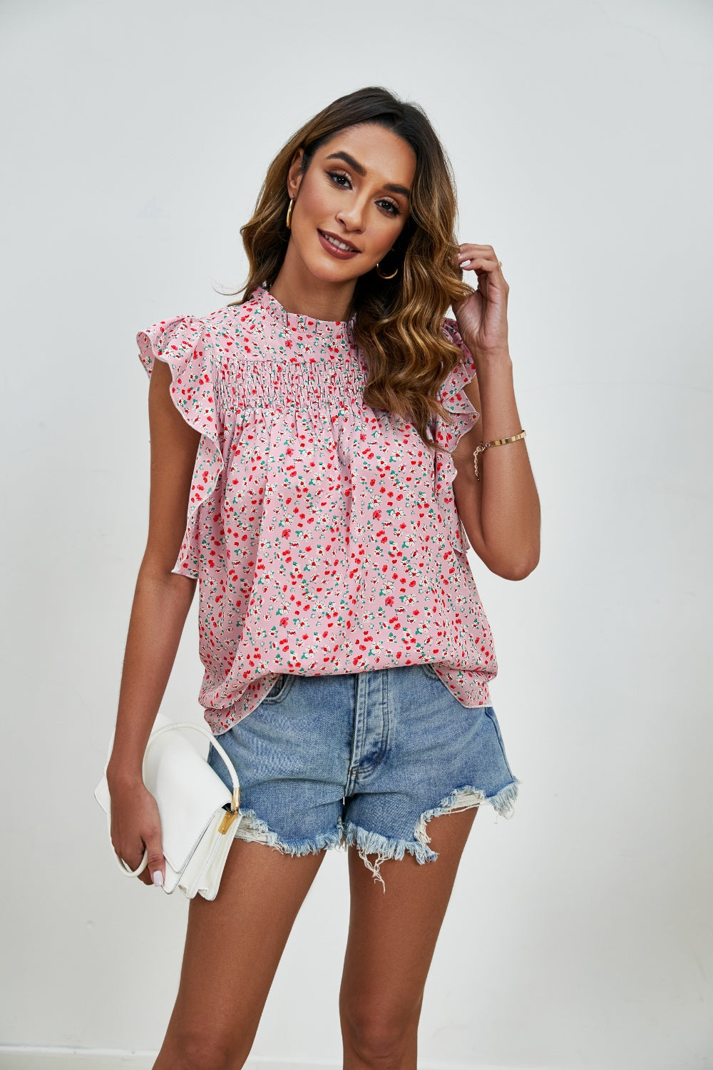 Blush pink floral smocked yoke ruffle sleeve blouse with mock neck.