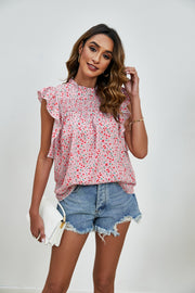 Blush pink floral smocked yoke ruffle sleeve blouse with mock neck.