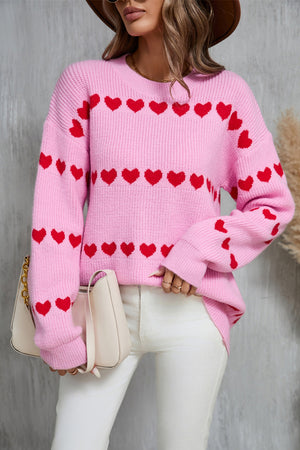 Pink knit pullover sweater with red heart stripes, crew neck, long sleeves.