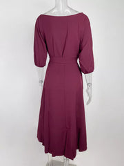 Burgundy off-the-shoulder belted dress with 3/4 sleeves and a flowing skirt.