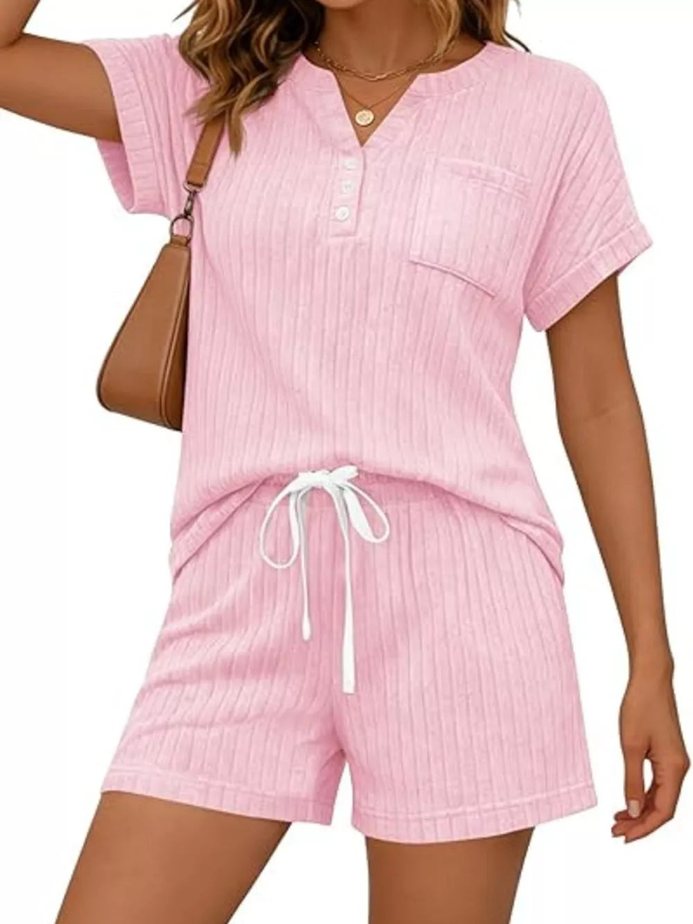 Pink ribbed knit loungewear set with drawstring shorts and henley top with pocket.