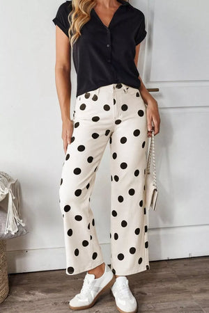Cream polka dot maternity jeans with a high rise and wide leg