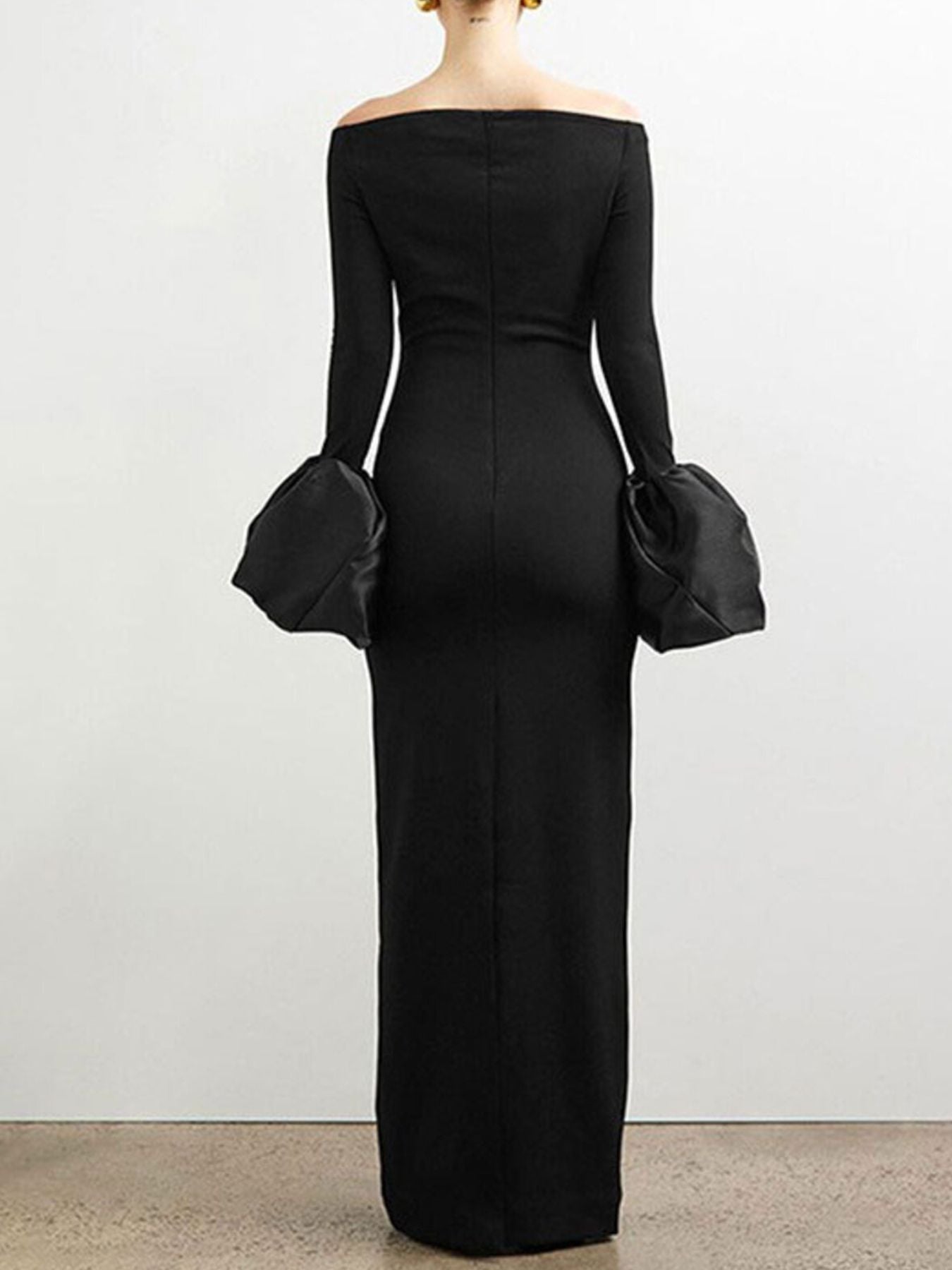 Black off-shoulder maxi dress with dramatic balloon sleeves and a bodycon fit.