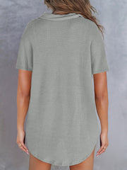 Gray waffle knit polo shirt with short sleeves and a button detail neckline.