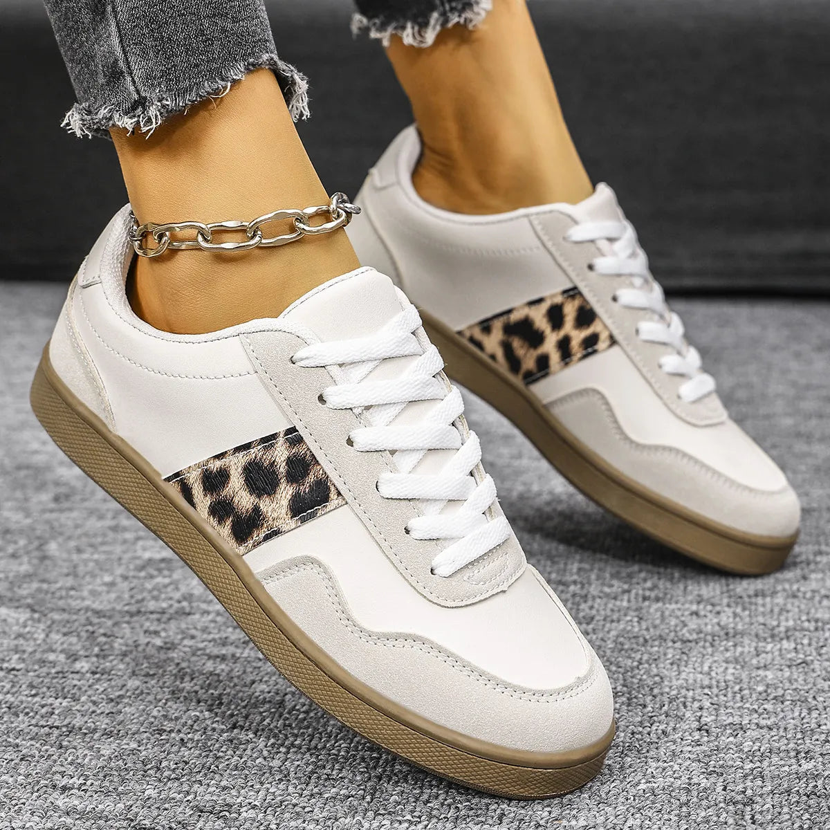 White retro sneakers with leopard print panels and suede accents.