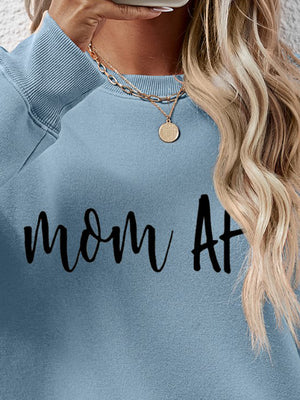 Misty Blue graphic sweatshirt with black Mom At text, crewneck, casual style.