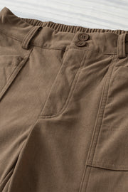 Seamed front wide leg trousers in caramel with button detail and elastic waistband.
