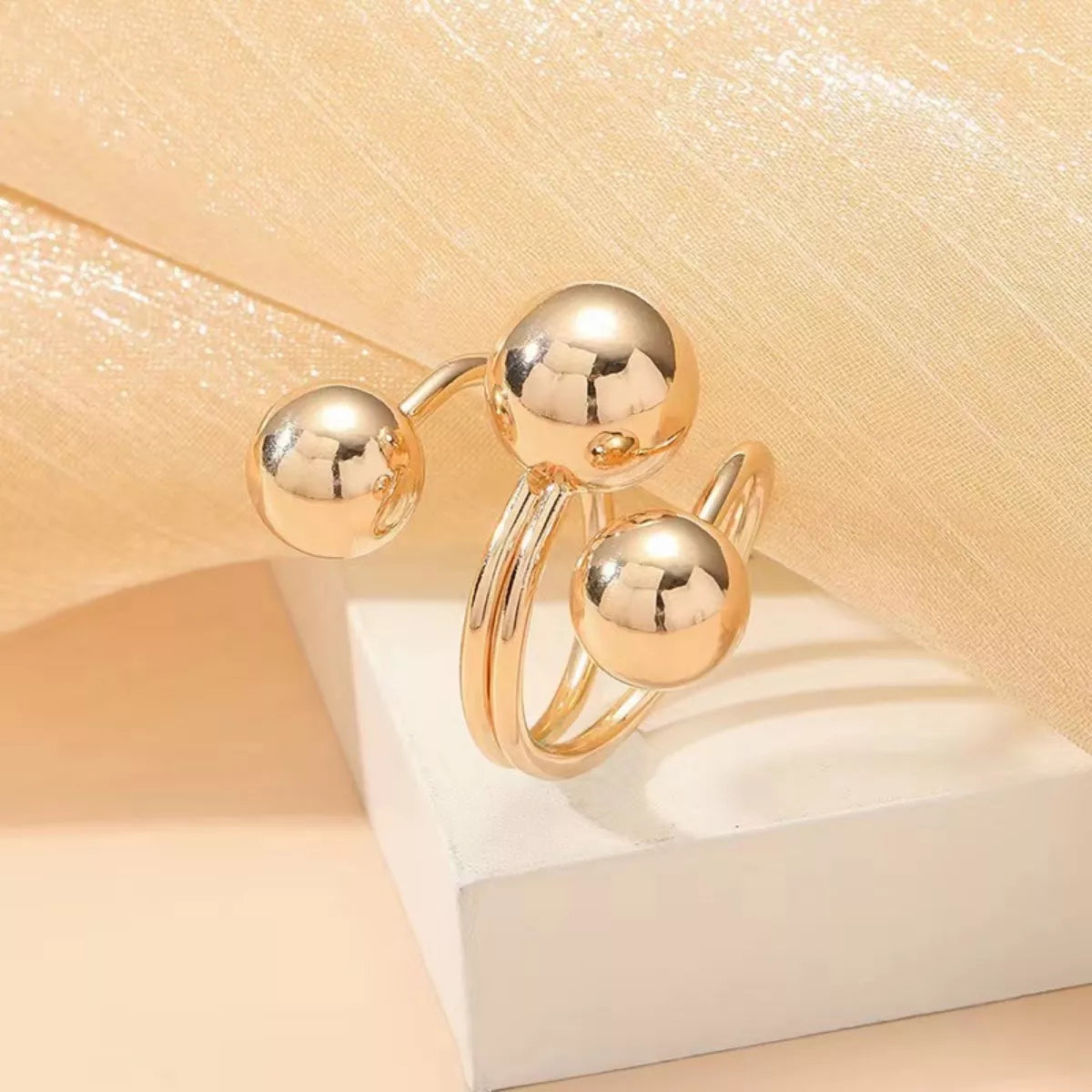 Gold multi-layered ball ring with alloy jewelry detail