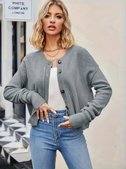 Gray acrylic button cardigan with textured knit and round neckline.