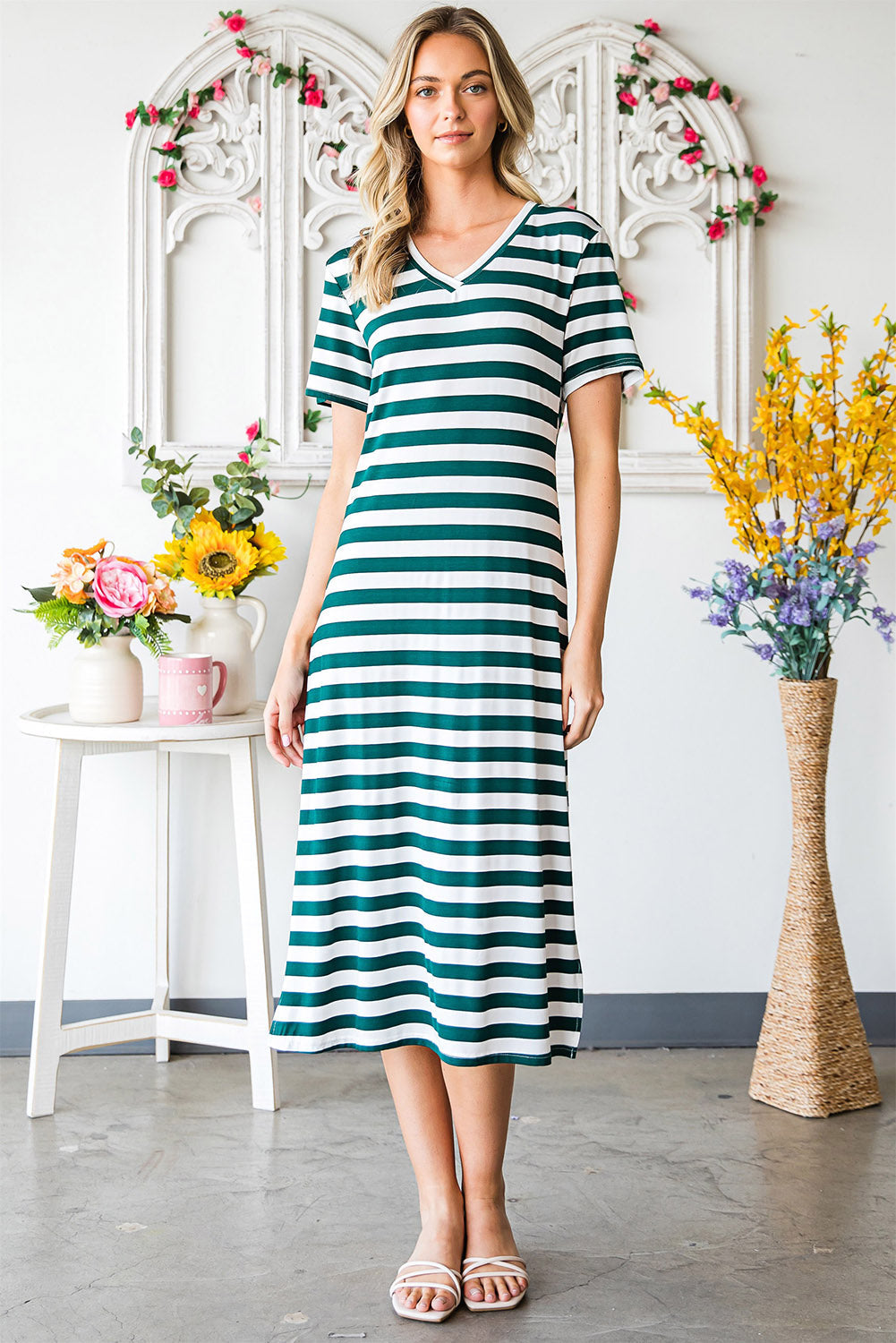 Striped jersey maxi dress with V-neck and short sleeves in green and white stripes.