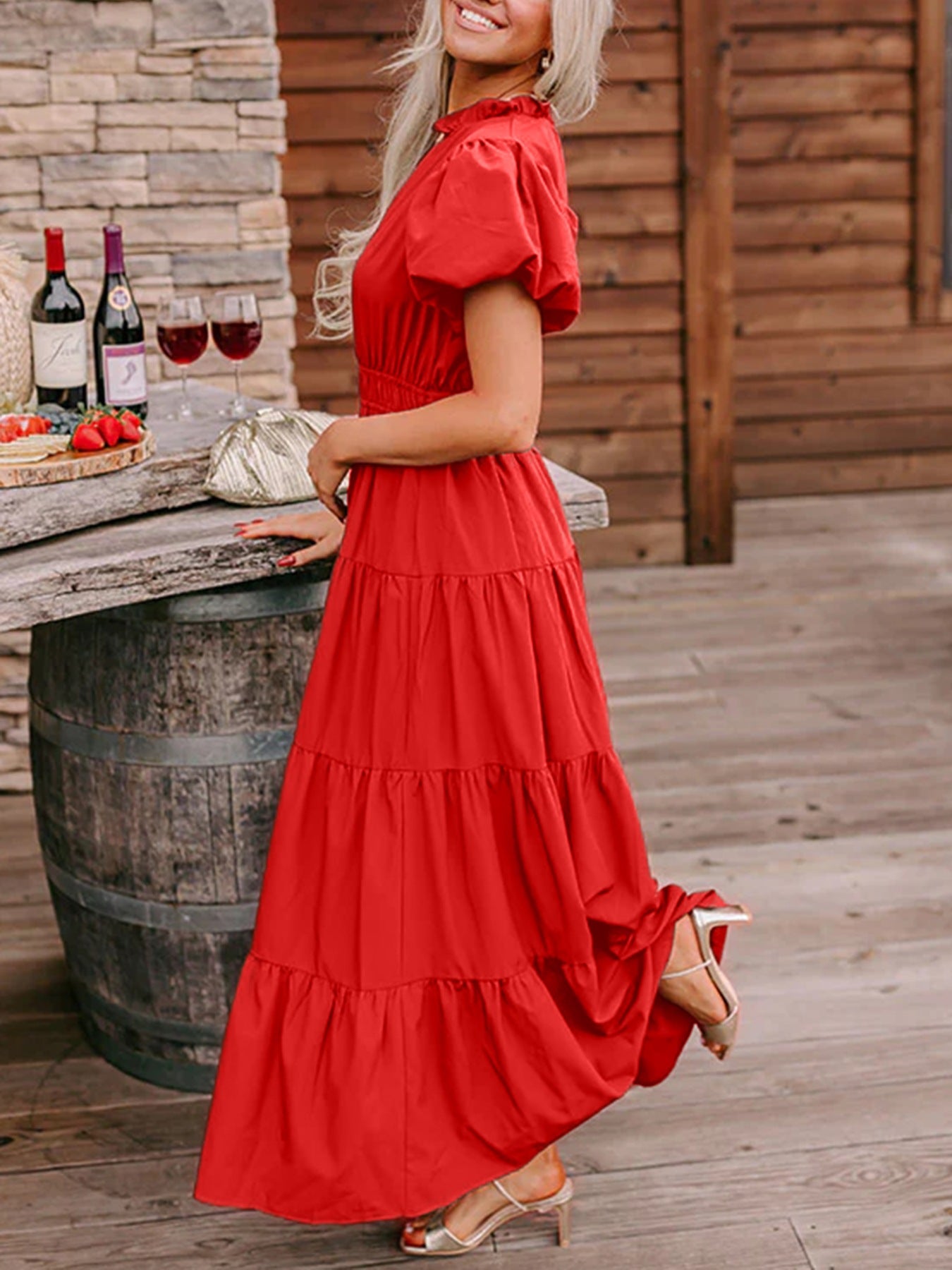 Deep red tiered maxi dress with puff sleeves and ruffled neckline.