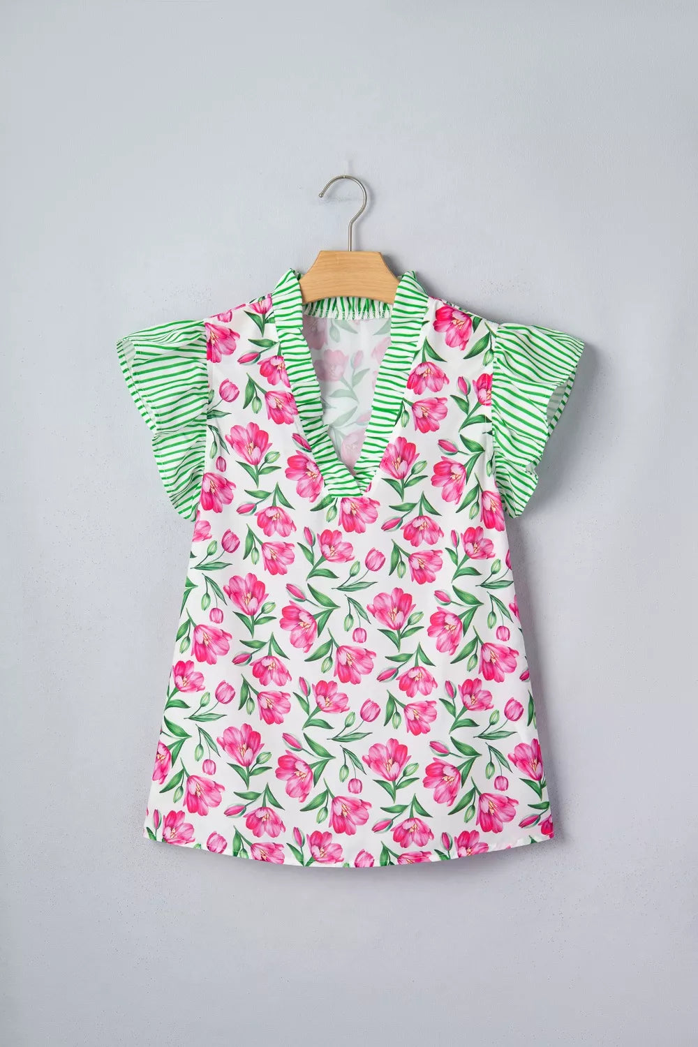 Tulip print ruffled V-neck polyester blouse with green striped trim and sleeves.