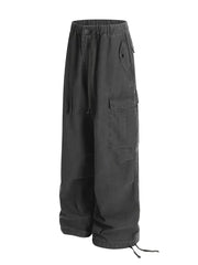 Grey cargo pants with adjustable drawstring waist and hem, featuring multiple pockets.