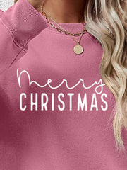 Blush Pink Merry Christmas graphic sweatshirt with crewneck and ribbed cuffs.