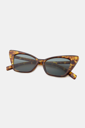 Sharp angular cat-eye sunglasses in brown tortoise shell acetate with dark lenses.