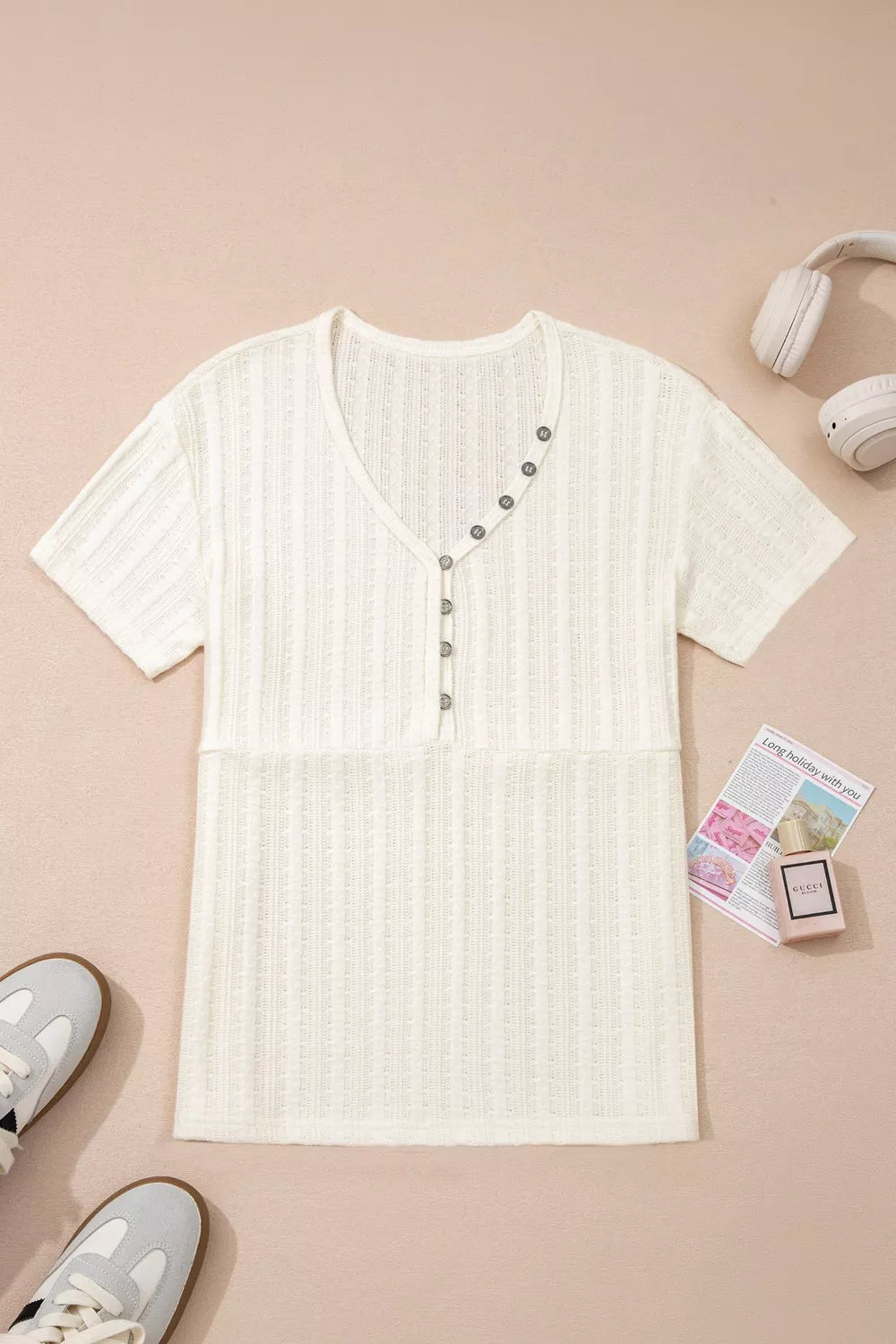 Textured V-neck maternity t-shirt in cream with button details and short sleeves.