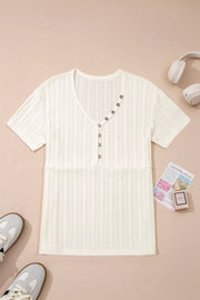 Textured V-neck maternity t-shirt in cream with button details and short sleeves.
