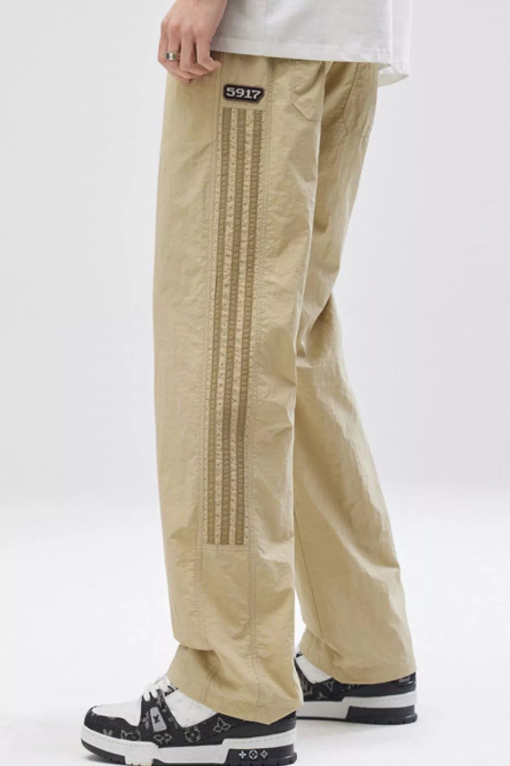 Khaki casual sweatpants with side stripe detail and number patch.
