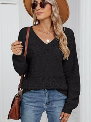 Black eyelet stitch V-neck pullover sweater with long sleeves and textured details.