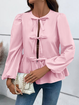 Blush pink peplum blouse with keyhole neckline and bow details, long puff sleeves