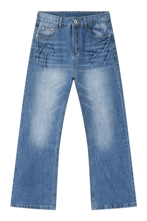 Baggy denim jeans in distressed medium wash with unique cracked detailing.