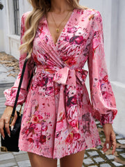 Floral wrap romper in Dusty Pink with blouson sleeves and tie waist, v-neckline.